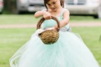 a flower girl dressed into a lovely mint blue tutu dress and a floral crown is a very cute option