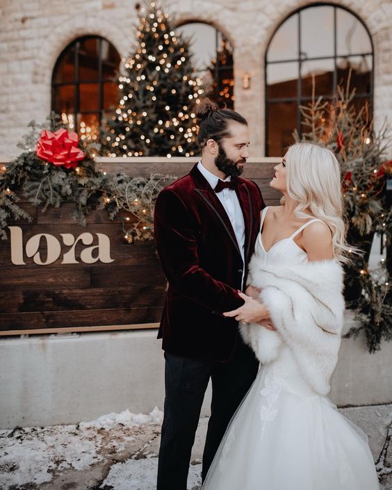 a glam mermaid wedding dress plus a white faux fur cover up for a chic and bold Christmas bridal look is amazing