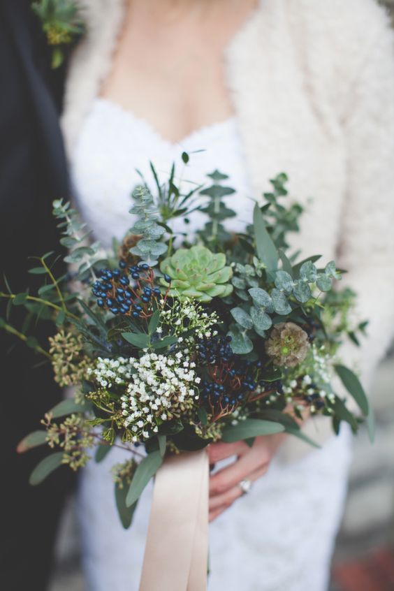 a gorgeous eucalyptus, privet berries, succulents and leaves wedding bouquet with blush ribbons