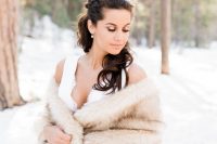 a luxurious neutral faux fur cover up will keep a bride warm and cozy and will add chic to her outfit at the same time