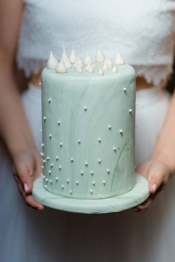 a mint watercolor wedding cake with beading and tiny meringues on top for a spring or summer wedding