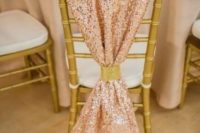 a pink sequin chair cover with a gold embellished ring is a stylish and glam idea for a wedding