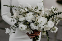 a pure white winter wedding bouquet with some greenery is a beautiful idea for a frozen effect