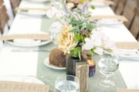a simple and cute wedding tablescape with a mint table runner, neutral linens and pastel and white blooms