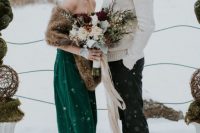 a strapless emerald wedding gown and a faux fur stole for a contrasting winter bridal look to stand out in the snow