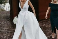 a structural white wedding gown with a front split and black ankle strap shoes for a minimalist look