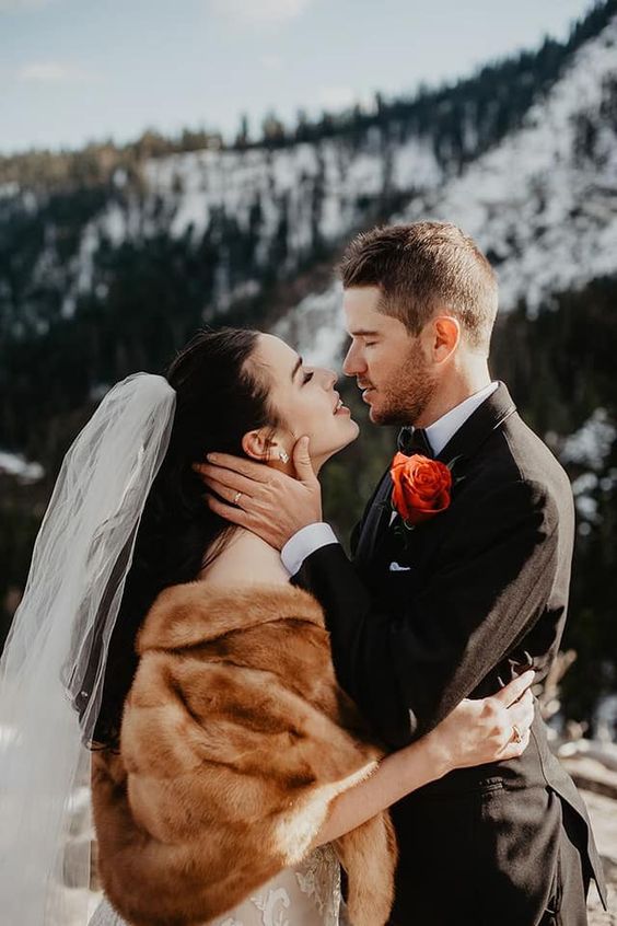 a warm beige faux fur cover up is a timeless idea for a winter bride and it will match many bridal looks