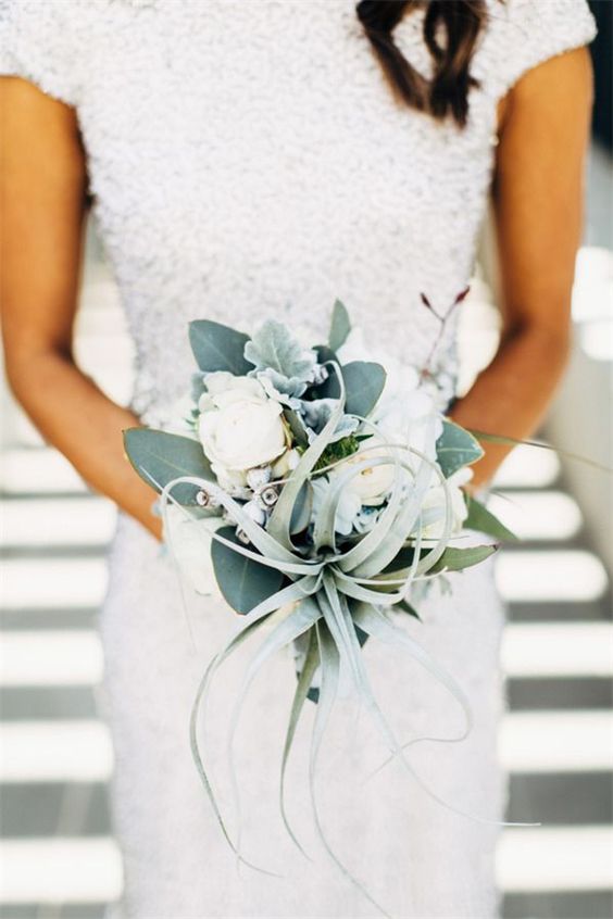 an air plant, pale leaves and some white blooms wedding bouquet for a non-traditional bride