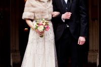 an art deco bridal outfit with an embellished A-line wedding dress with a neutral faux fur cropped jacket with short sleeves