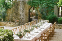 blush tablecloths and tulle overlays, blush flower and greenery centerpieces for these long tables