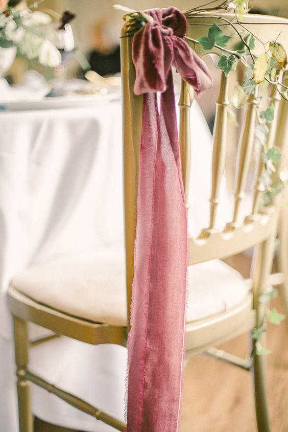 chic mauve ribbon with a bow on top and some foliage is a lovely idea for an elegant wedding with color