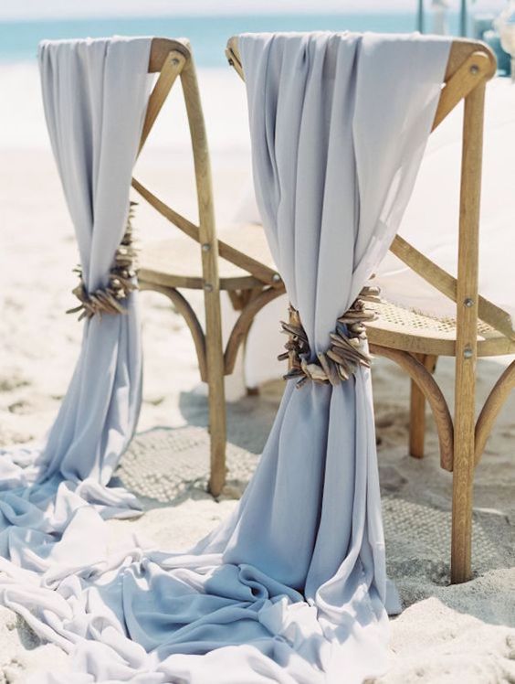 dusty blue wedding chair covers with driftwood are amazing for a coastal or beach weddings