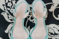 mint blue wedding shoes with large bows for a whimsy and cute bridal look