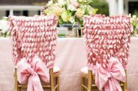 pink wedding chair covers with petals and large bows are amazing for a wedding with a pastel touch, they look glam and cool