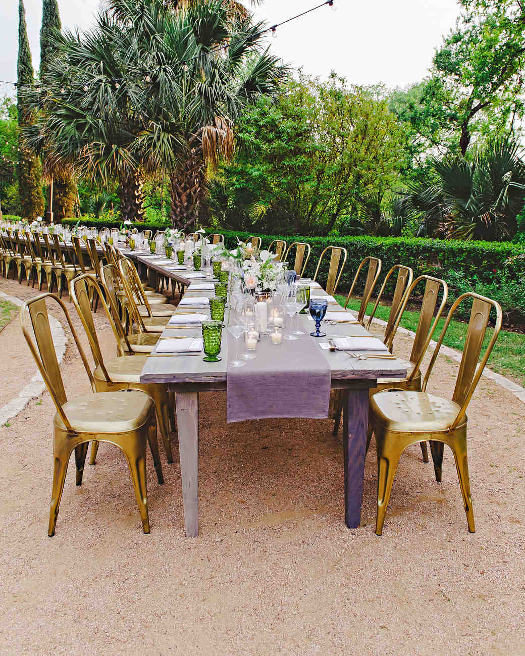 Purple and gold seating plus green and blue mismatched goblets made this curving reception table