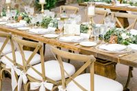 stained chairs with white seats and white ribbon bows are an elegant and chic idea for a farmhouse wedding or a countryside one but with an elegant feel