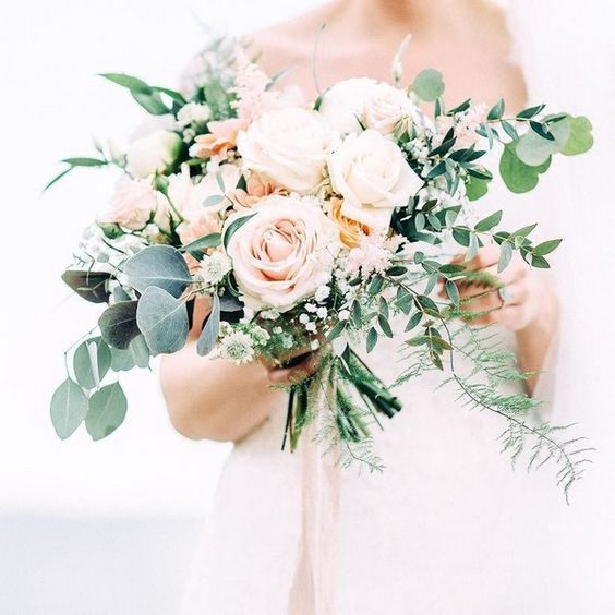 a beautiful blush and cream rose wedding bouquet with textural greenery for a neutral-colored wedding