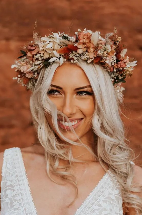 a beautiful boho fall wedding crown with lots of dried blooms and foliage, in rustic and creamy shades is a fantastic idea