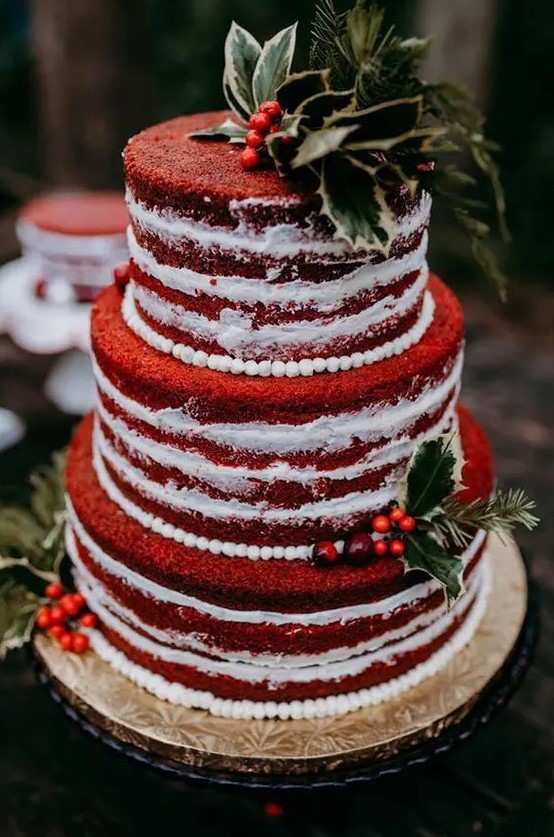 a beautiful red velvet wedding cake with white sugar beads, berries, greenery and leaves is amazing for a relaxed and rustic Christmas wedding