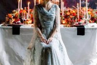 a blue star embroidery wedding dress with a draped bodice, long sleeves and a train for a fairy tale bride
