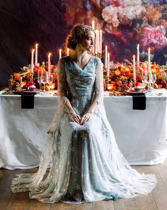 a blue star embroidery wedding dress with a draped bodice, long sleeves and a train for a fairy tale bride