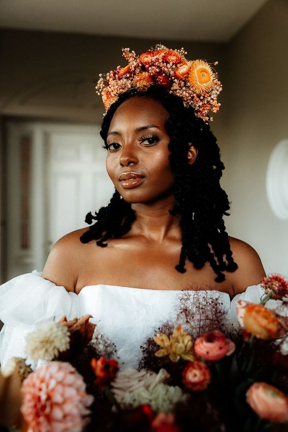 a bright red and yellow dried flower crown with smaller fillers is a gorgeous idea for a fall or summer boho bride
