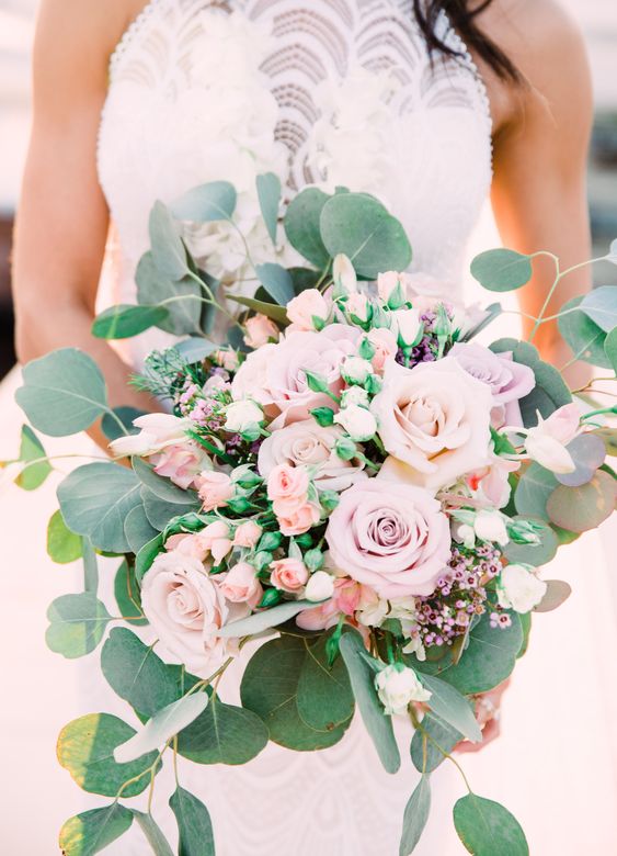 a chic blush and lilac wedding bouquet with various kinds of blooms and greenery