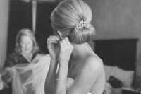 a chic vintage wedding hairstyle with a volume on top and a chignon plus a shiny hairpiece
