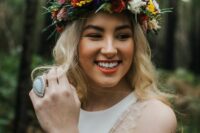 a colorful flower crown with pink, white, yellow, red and blue blooms, berries, greenery and thistles is a lovely idea for summer