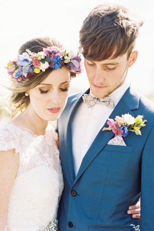 a colorful flwoer crown with blue, purple, red blooms, berries, foliage and billy balls is a perfect idea for a colorful wedding