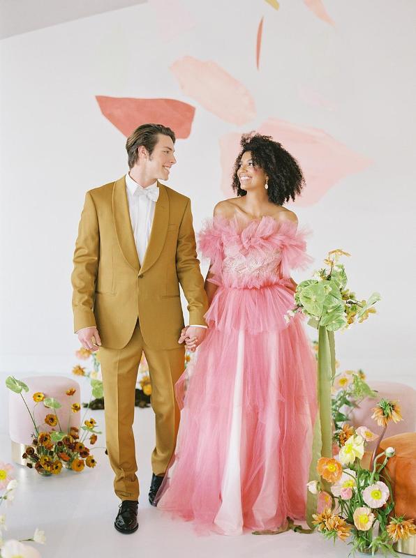 a creative pink strapless A-line wedding dress with a tulel bodice and skirt plus statement earrings is a gorgeous candy-colored idea