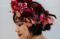a deep-colored flower crown with red and burgundy blooms and greenery is a gorgeous idea for a fall boho bride