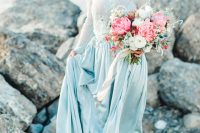 a delicate pastel blue A-line wedding dress wiht a lace bodice, long sleeves and a plain silk skirt is a very subtle and lovely idea