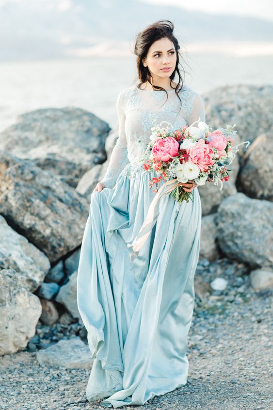 a delicate pastel blue A-line wedding dress wiht a lace bodice, long sleeves and a plain silk skirt is a very subtle and lovely idea