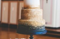 a dreamy navy, white and gold glitter wedding cake with a gold calligraphy cake topper is a gorgeous idea for a glam wedding in these colors