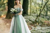 a fairy-tale-like green off the shoulder wedding dress in light green and white and with a train is a beautiful idea