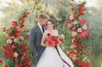 a fantastic red and pink wedding altar with lots of greenery will be a gorgeous idea for a wedding with such a color scheme