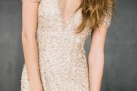 a fitting glitter wedding dress with a covered plunging neckline, short sleeves is amazing for a shiny holiday or just glam wedding