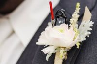 a funny wedding boutonniere of a blush bloom and a Star Wars Lego figurine