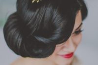 a gorgeous curled updo with a twisted front and a gold headpiece with rhinestones