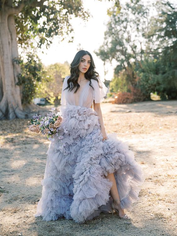 a jaw-dropping lavender A-line wedding dress with a tulle bodice and a layered skirt with a train plus silver shoes