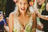 a jaw-dropping oversized colorful flower crown with pink, hot pink, peachy peonies and roses, billy balls, berries and fern is amazing for a colorful wedding
