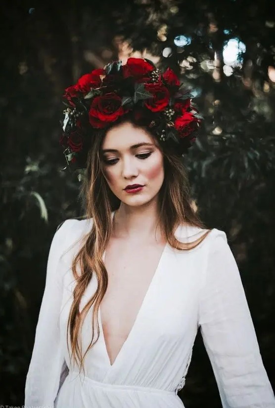 a large moody crown with red roses and dark greenery for a fall boho bridal look