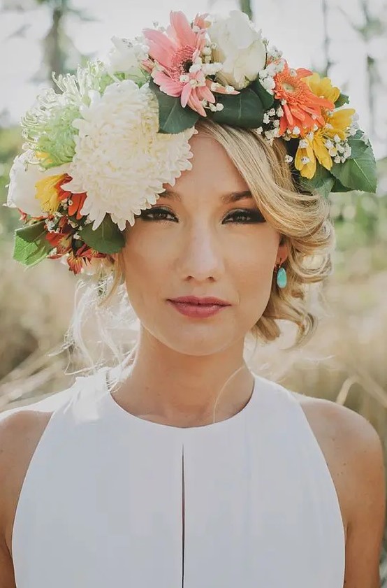 a large summer floral crown with neutral, pink, yellow and orange blooms plus greenery is a gorgeous idea if you want some color