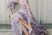 a lilac floral print A-lie wedding dress with bell sleeves, a V-neckline and a tiered skirt for a very romantic garden wedding
