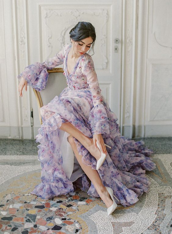 a lilac floral print A-lie wedding dress with bell sleeves, a V-neckline and a tiered skirt for a very romantic garden wedding
