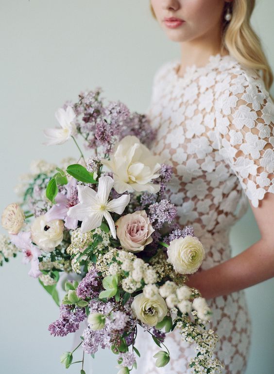 a lilac, white and blush wedding bouquet with plenty of greenery and texture for a spring wedding