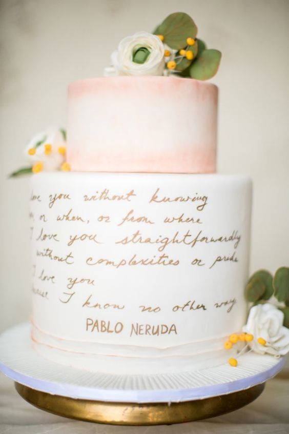 a lovely and chic wedding cake with a peachy pink tier and a love letter one, with white blooms and yellow berries is a romantic idea
