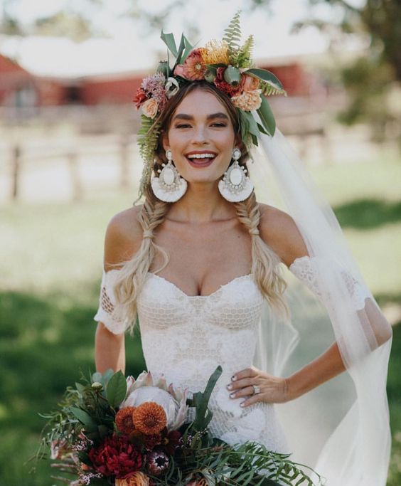 a lovely boho bridal crown with neutral, pastel and bright blooms, large leaves and a seed pod is a fantastic idea for a boho bride