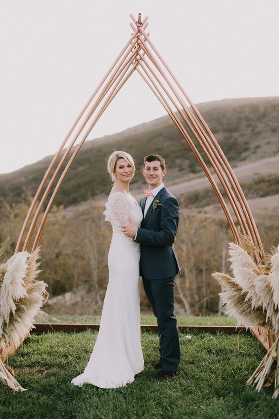 a modern boho wedding altar of copper and pampas grass is stylish, laconic and chic